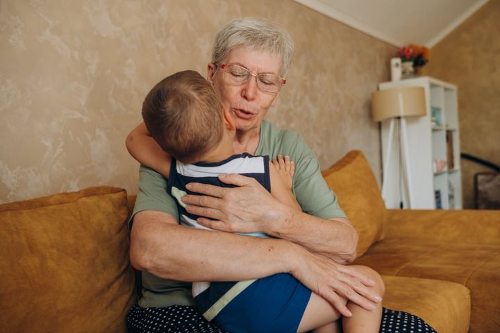 grandmother calms a crying child
