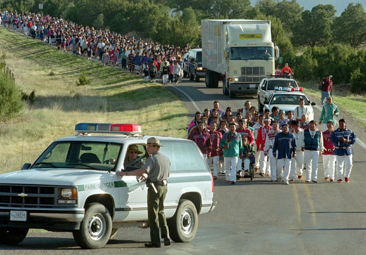 Hundreds of Native Americans march in a procession along with a truck carrying 2,000 skeletal remains of Jemez Pueblo Indian ancestors to be reburied in the Pecos National Historical Park in Pecos, N.M., on May 22, 1999. The remains, which were excavated from Pecos Pueblo between 1915 and 1929 by archaeologist Alfred V. Kidder, were returned from Harvard University. The return of the Pecos remains and funerary items, which represent a wealth of scientific knowledge of the American Southwest, is the largest and perhaps most significant transfer under the 1990 Native American Graves Protection and Repatriation Act.
