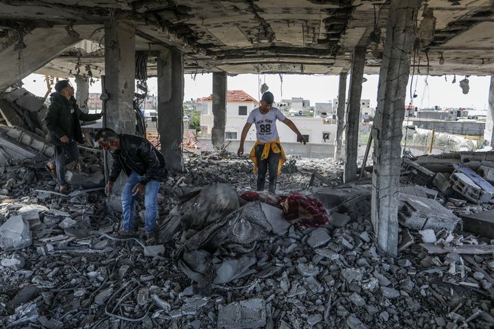 RAFAH, GAZA - Residents collect usable items around the rubble of the destroyed house of the Palestinian al-Tawabte family following the Israeli attack in Rafah, Gaza on March 22, 2024. (Photo by Abed Rahim Khatib/Anadolu via Getty Images)