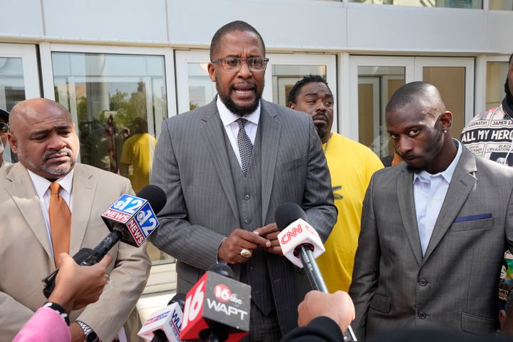 Civil lead counsel Malik Shabazz (center) speaks to reporters following the sentencing of a fourth former Rankin County law enforcement officer, while his client Michael Corey Jenkins (right) and co-counsel Trent Walker (left) listen outside a federal courthouse in Jackson, Mississippi, on March 20.