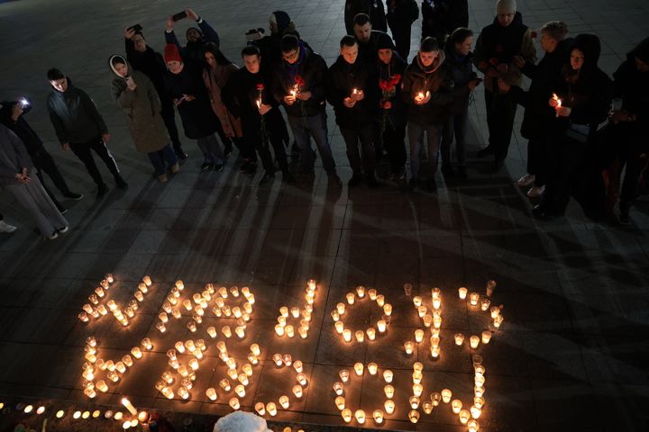 People lay flowers and lit candles in memory of the Moscow concert gun attack victims in the center of Simferopol, Crimea, on March 22, 2024. (Photo by STRINGER/AFP via Getty Images)