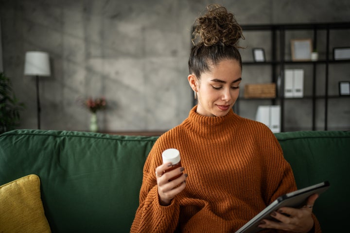 Young woman taking medication