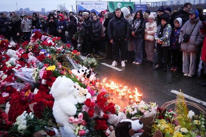 People gather to lay flowers and light candles next to the Crocus City Hall, on the western edge of Moscow, Russia, Saturday, March 23, 2024. (AP Photo/Alexander Zemlianichenko)