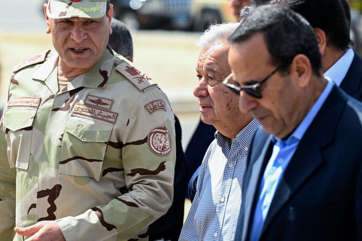 UN Secretary-General Antonio Guterres (C) walks on the tarmac flanked by the Egyptian Second Army in Sinai Chief Mohammad Abdel Rahman (L) and North Sinai Governor Mohammad Shousha (R), upon landing at Egypt's al-Arish Airport, near the Rafah border with the Gaza Strip on March 23, 2024, amid ongoing battles between Israel and the Palestinian militant group Hamas.