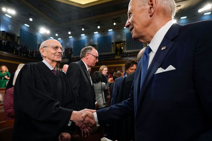 President Joe Biden shakes hands with retired Justice Stephen Breyer after the State of the Union address in the House Chamber of the Capitol in Washington, D.C., on Feb. 7, 2023.