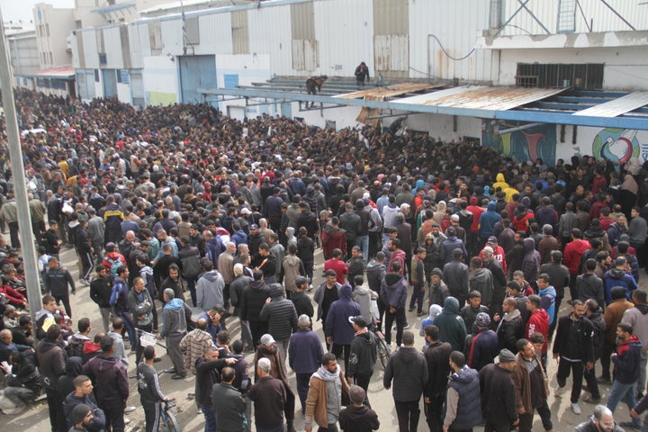 Palestinians wait in front of the United Nations Relief and Works Agency for Palestine Refugees in the Near East distribution center to receive a limited amount of flour as Israeli attacks continue on Gaza City, Gaza, on March 18.