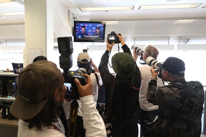 Photographers crowd the press room of the Los Angeles Dodgers as Shohei Ohtani reads a statement Monday.