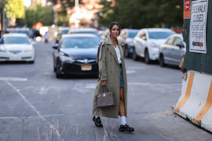 YouTuber Tamara Kalinic seen wearing visible white socks and black shiny leather loafers from Prada during New York fashion week, in September 2022.