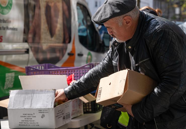 People receive food at a weekly distribution by the ICNA Relief Hunger Prevention Program in Brooklyn on Oct. 16. After pandemic food assistance ended, more than 1.7 million New York City residents rely on food stamps. 