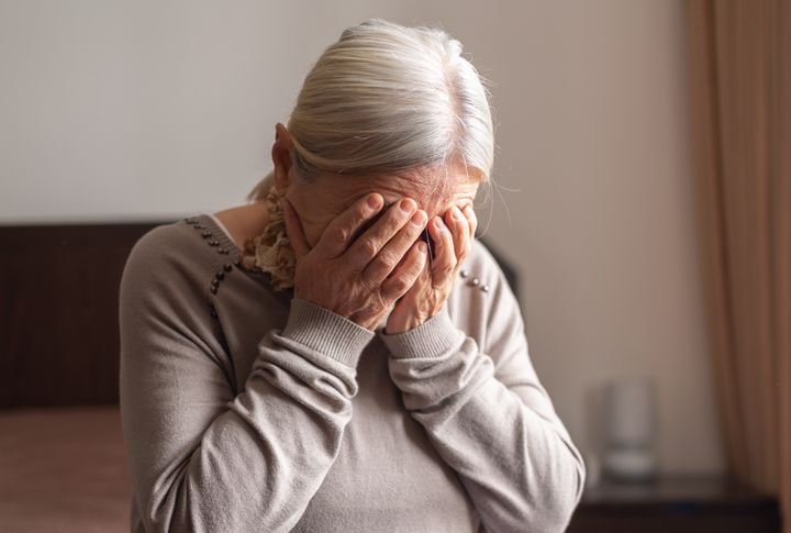 Depressed Senior Woman Covered Her Face With Both Hands