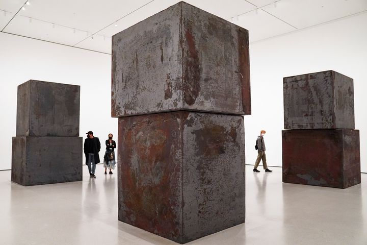 Guests browse Richard Serra's "Equal" at the Museum of Modern Art in the new fall exhibition spaces, Nov. 13, 2020, in New York.