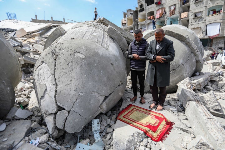 Palestinians pray during the second Friday prayer of the holy month of Ramadan on the ruins of Al-Farouq Mosque, which was destroyed by Israeli air strikes on March 22, 2024 in Rafah, Gaza.