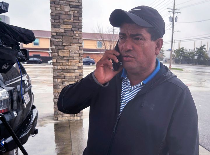 Carlos Suazo Sandoval speaks with a reporter on the phone, Wednesday, March 27, 2024 in Dundalk, Md. One of the construction workers presumed dead in Baltimore was a 38-year-old father and Sandoval's younger brother, Maynor Yassir Suazo Sandoval, who had been in the United States for 18 years but “always dreamed of, in his old age, retiring peacefully in Honduras.” (AP Photo/Brian Witte)