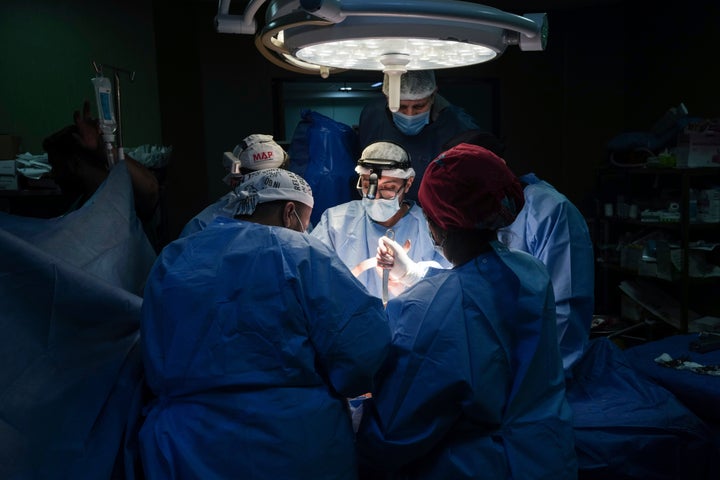 Doctors perform surgery on a patient at Al-Aqsa Martyrs Hospital, in Deir al-Balah, central Gaza, Sunday, March 17, 2024. An international team of doctors has been working the past two weeks at the facility amid shortages of supplies.