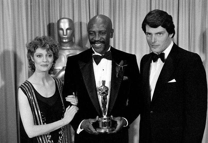 Louis Gossett Jr., is flanked by presenters Susan Sarandon and Christopher Reeve, as he poses with the Oscar awarded to him as best supporting actor in "An Officer and a Gentleman," at the annual Academy Awards presentation in Los Angeles, Calif., on April 11, 1983. (AP Photo)
