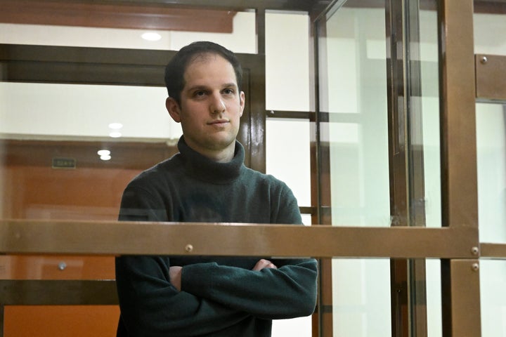 Wall Street Journal reporter Evan Gershkovich stands in a transparent cage in a courtroom at the Moscow City Court in Moscow on Dec. 14, 2023.