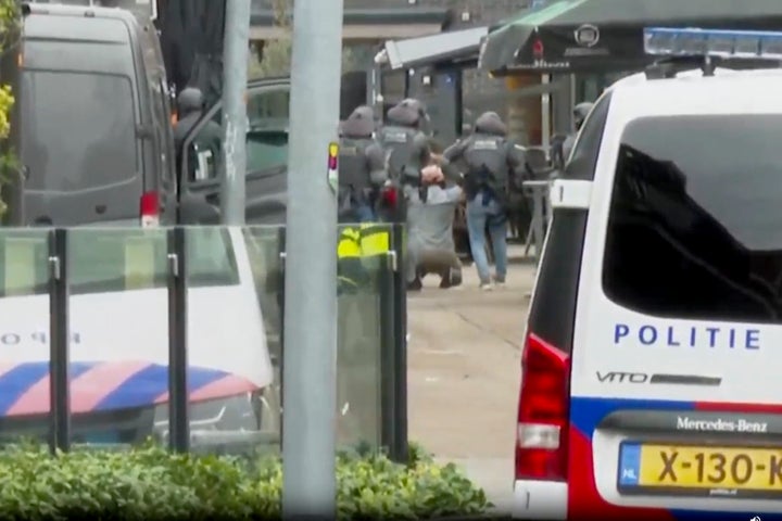 This framegrab from video shows a suspected hostage-taker surrendering to police after a tense hours-long standoff in the central Dutch town of Ede, Netherlands, Saturday, March 30, 2024.