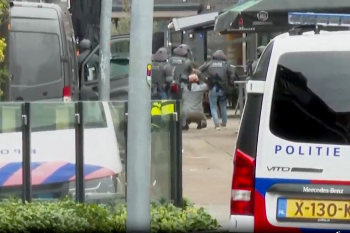 This framegrab from video shows a suspected hostage-taker surrendering to police after a tense hours-long standoff in the central Dutch town of Ede, Netherlands, Saturday, March 30, 2024. 