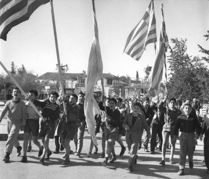 Carrying Greek flags, Greek Cypriots school boys jubilate in the streets of Nicosia, Cyprus, May 25, 1959, after it was announced that the emergency regulations would be revoked and that the exiled Archbishop Makarios, the Ethnarch, is permitted to return. (AP Photo)