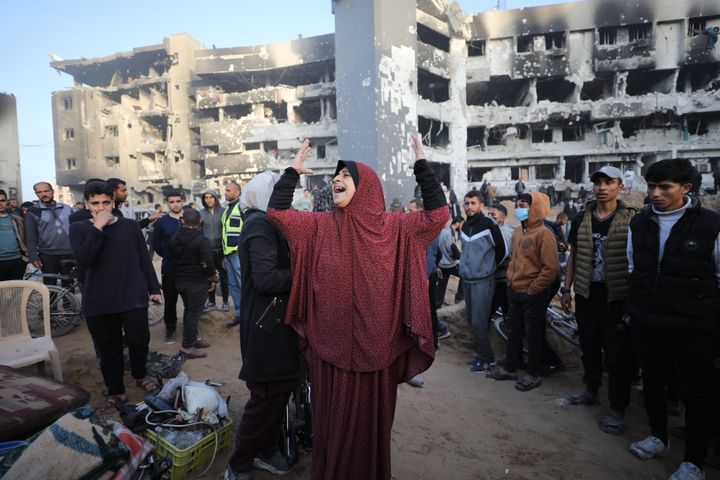 A woman mourns as Palestinians gather around the destroyed al-Shifa Hospital, after Israeli forces withdrew from medical complex in Gaza City, Gaza on April 1, 2024.