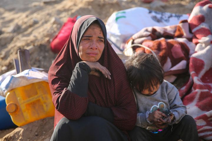 A Palestinian woman and a child sit amidst the rubble of Gaza's al-Shifa Hospital on April 1, 2024, after the Israeli military withdrew from its two-week siege on the medical complex.