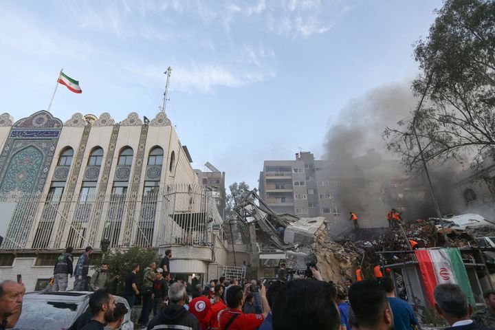 Emergency and security personnel search the rubble at the site of strikes which hit a building annexed to the Iranian embassy in Syria's capital Damascus, on April 1, 2024. Syrian state media said Israeli strikes hit an Iranian consular annex in the capital on April 1, while a war monitor reported eight people were killed and Iranian state media said a senior commander of the powerful Islamic Revolutionary Guard Corps was among the dead, amid rising regional tensions due to the Gaza war. (Photo by LOUAI BESHARA / AFP) (Photo by LOUAI BESHARA/AFP via Getty Images)