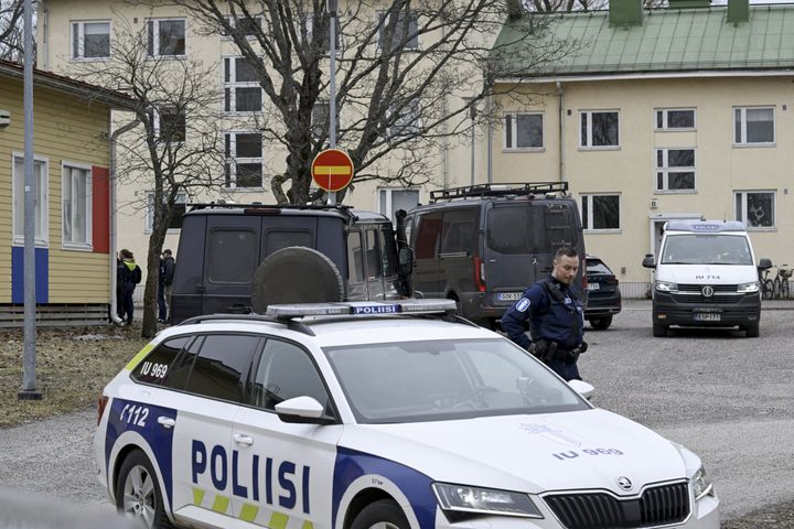 Finnish police officers and police vehicles are seen at the primary Viertola comprehensive school where a child opened fire and injured three other children, on April 2, 2024, in Vantaa, outside the Finnish capital Helsinki.