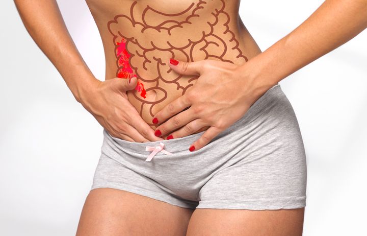 woman massaging her painful stomach