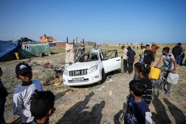 People inspect the site where World Central Kitchen workers were killed in Deir al-Balah, Gaza Strip.