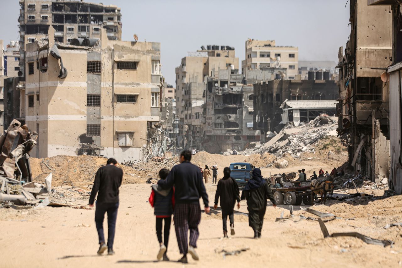 Palestinians walk among extensive destruction Tuesday after the Israeli army withdrew from the Al-Shifa Hospital and the surrounding areas west of Gaza City.