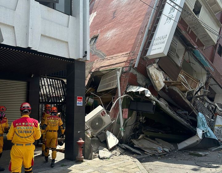 In this photo released by the National Fire Agency, members of a search and rescue team prepare outside a leaning building in the aftermath of an earthquake in Hualien, eastern Taiwan on April 3, 2024. 