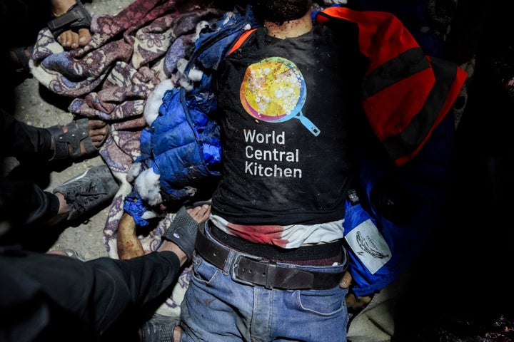 The body of a World Central Kitchen worker lies on the ground Monday at the Al-Aqsa Hospital in Deir al-Balah, Gaza. An Israeli attack on an aid convoy delivering food killed seven of the charity's workers.