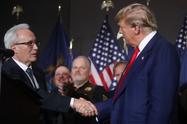 Former U.S. President Donald Trump speaks with James Tignanelli, with the Police Officers Association of Michigan as he attends a campaign event on April 02, 2024 in Grand Rapids, Michigan.