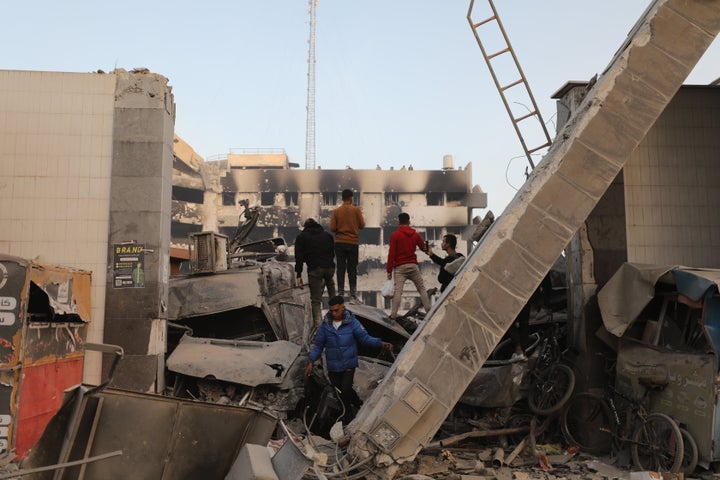 Palestinians gather around the burned and destroyed Al-Shifa Hospital after the Israeli attacks as Israeli forces withdrew from Al-Shifa hospital in Gaza City, Gaza on April 1, 2024. (Photo by Dawoud Abo Alkas/Anadolu via Getty Images)