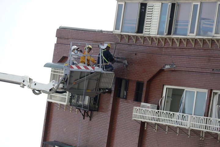 A structural engineer takes samples from a leaning building a day after a powerful earthquake struck, in Hualien City, eastern Taiwan, on April 4, 2024.