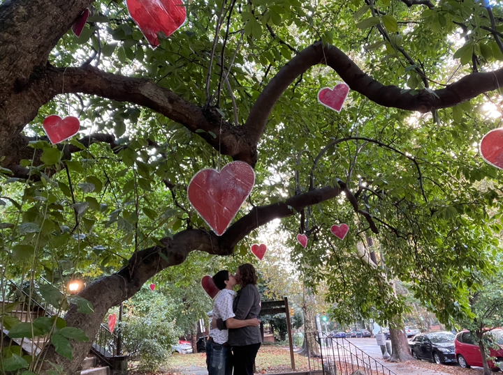 The author (right) and Quinn under their favorite magnolia tree after proposing to each other in September 2023.