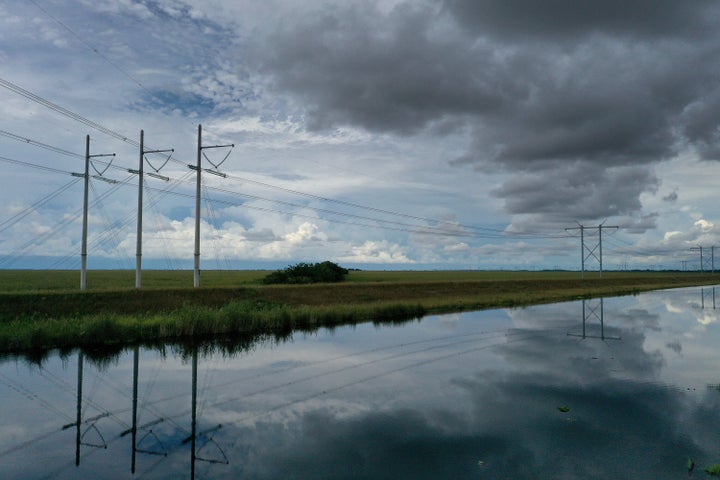 Electric power lines are attached to the transmission tower along the power grid on Sept. 28, 2023, in the Everglades, Florida.