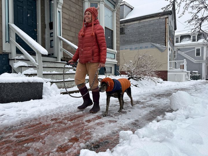 Lisa Silverman walks her dog Riley after an early-spring Nor'easter on April 4, in Portland, Maine.