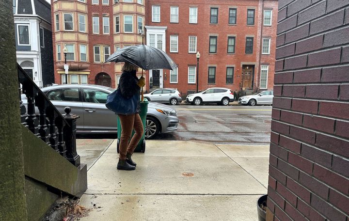 A person walks through the rain on April 4, 2024 in Boston. An early spring nor'easter is hammered the Northeast with heavy snow, rain and high winds, with some northern areas expected to get up to two feet of snow.