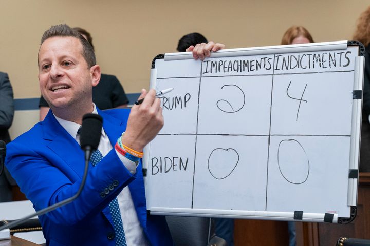 Rep. Jared Moskowitz (D-Fla.) holds up a whiteboard at a Sept. 28 House Oversight Committee inquiry on impeaching President Joe Biden. On it, he compares the impeachments and indictments of former President Donald Trump to Biden's.