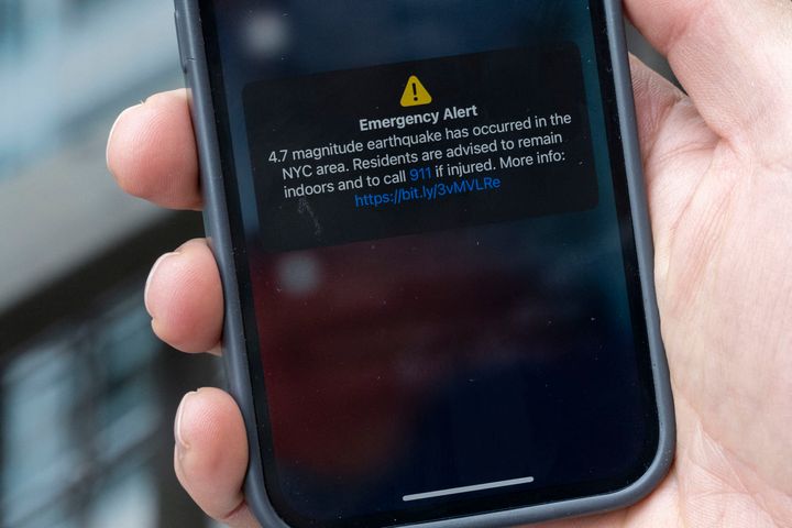 In this illustration, a phone shows an Emergency Alert message on April 5, 2024, warning of an earthquake in New York. New York City was shaken by a small earthquake on Friday with a 4.8 magnitude and an epicenter in neighboring New Jersey, according to the US Geological Survey (USGS). There were no initial reports of injuries or damage. In Brooklyn buildings shook, rattling cupboard doors and fixtures, an AFP correspondent reported. (Photo by ANGELA WEISS / AFP) (Photo by ANGELA WEISS/AFP via Getty Images)