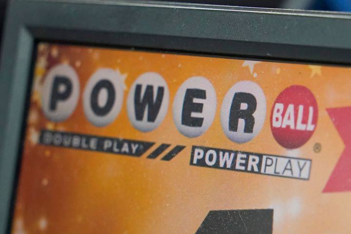 FILE - A display panel advertises tickets for a Powerball drawing at a convenience store, Nov. 7, 2022, in Renfrew, Pa. (AP Photo/Keith Srakocic, File)