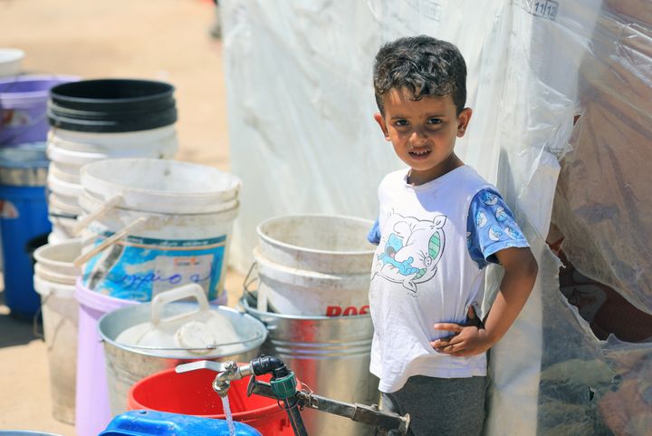 A Palestinian child waits to fill buckets and plastic containers with water at the fountain to combat thirst while daily life continues in Rafah, Gaza on April 6, 2024. Palestinians who escaped from Israeli attacks and took shelter in the city of Rafah are trying to continue their daily lives in makeshift tents under difficult conditions and with limited resources.