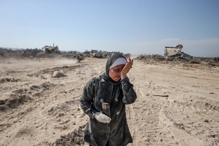 Palestinian families returning to their homes pass debris of destroyed buildings after Israeli forces withdraw from parts of Khan Younis, Gaza on April 7, 2024.