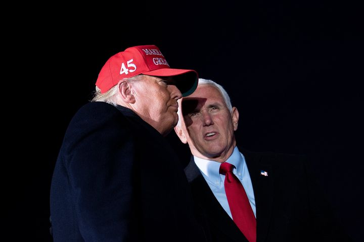 Then-President Donald Trump arrives with then-Vice President Mike Pence for a Make America Great Again rally at Cherry Capital Airport in Traverse City, Michigan on Nov. 2, 2020.