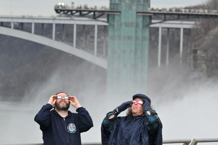 People look up at the sun during a total solar eclipse across North America, at Niagara Falls State Park in Niagara Falls, New York, on April 8, 2024. (Photo by ANGELA WEISS/AFP via Getty Images)