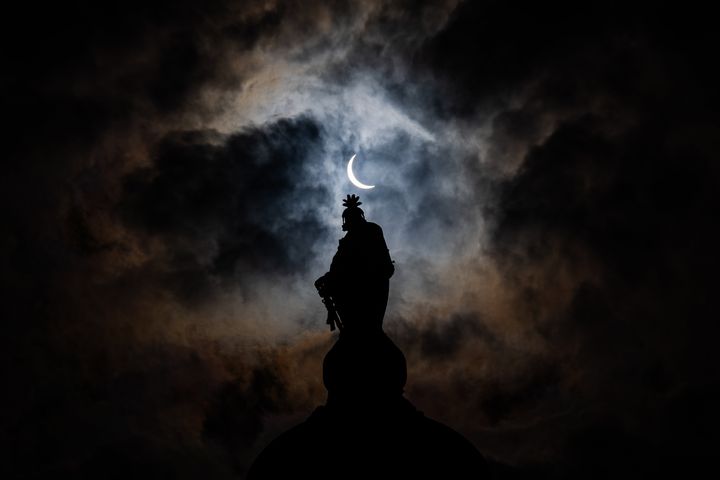 The partial solar eclipse is seen above the Statue of Freedom atop the dome of the U.S. Capitol Building on Capitol Hill on April 8, 2024 in Washington, DC. (Photo by Andrew Harnik/Getty Images)