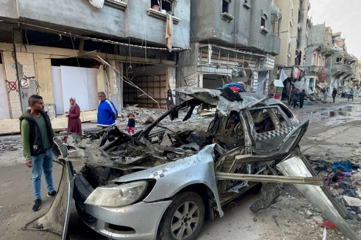 Onlookers check the car in which three sons of Hamas leader Ismail Haniyeh were reportedly killed in an Israeli air strike in al-Shati camp, west of Gaza City on April 10, 2024. Haniyeh, based in Qatar, said his three sons and three grandchildren had been killed in the strike in an interview with Al Jazeera.