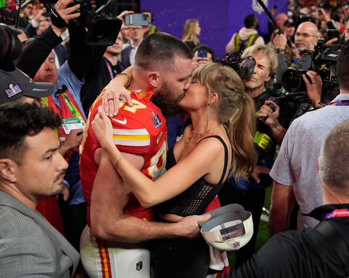 Kansas City Chiefs tight end Travis Kelce and singer-songwriter Taylor Swift share a kiss after the Chiefs' Super Bowl victory in February.