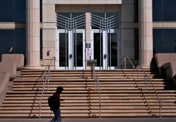 A person walks past the Arizona Supreme Court building, Wednesday, April 10, 2024, in Phoenix. The Arizona Supreme Court ruled Tuesday that the state can enforce its long-dormant law criminalizing all abortions except when a mother's life is at stake. 
